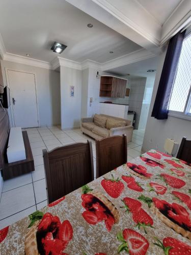 a living room with a table with strawberries on it at Guarapari Praia - 2 quartos 1 banheiro ar condicionado in Guarapari