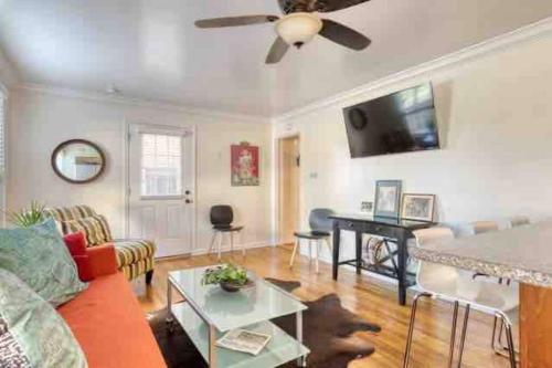 a living room with a couch and a ceiling fan at Belmont Shore Beach Bungalow, 2 min walk to town! in Long Beach