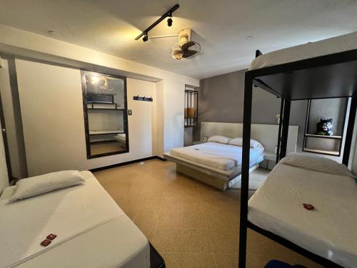 a bedroom with two bunk beds and a mirror at Hotel Natural Medellin in Medellín
