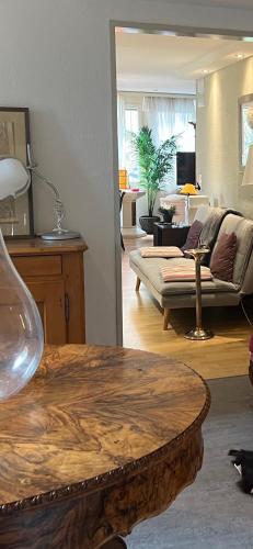 a living room with a table and a couch at Romantic Space in Nussbaumen