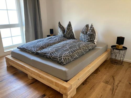 a bed with pillows on a wooden platform in a room at Ferienwohnung Zweinig 04 in Roßwein