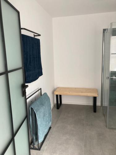 a bathroom with a wooden table and a bench at Ferienwohnung Zweinig 04 in Roßwein
