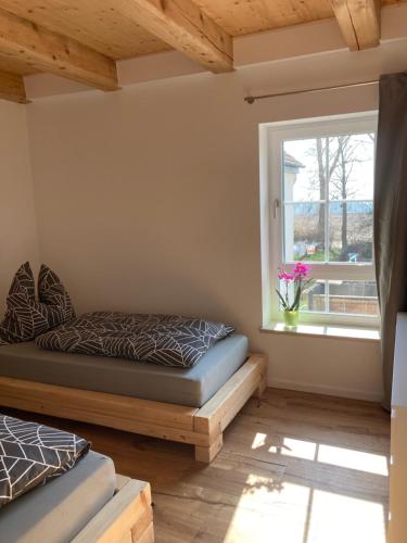 a bedroom with a bed and a window at Ferienwohnung Zweinig 04 in Roßwein