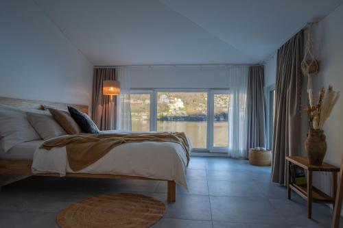 a bedroom with a bed and a large window at Villa Patria B&B in Brusino Arsizio