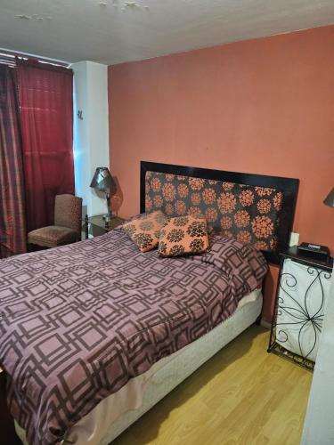a bedroom with a bed with two pillows on it at Departamento Céntrico CDMX in Mexico City
