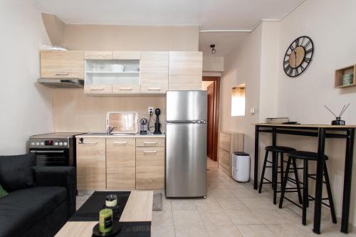 a kitchen and living room with a stainless steel refrigerator at Unique Apartment in Alexandroupoli