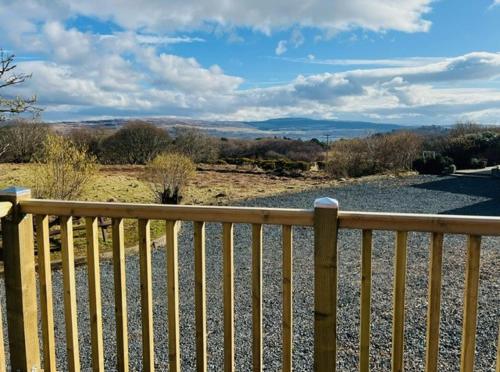 a wooden fence on the side of a road at Hidden Hut - Aros View - Tobermory in Tobermory