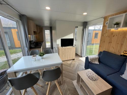 a living room with a couch and a table at Holiday Home Tiny Haus Anellie by Interhome in Riedenburg