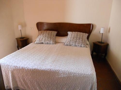 a bed in a room with two nightstandumentsuments at Agriturismo Le Macine in Florence