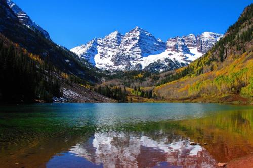 a mountain reflecting in a lake in the mountains at Woodbridge Unit 29E in Snowmass Village
