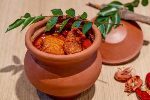 a small vase with food in it on a table at Holiday Inn Express Bengaluru Bommasandra by IHG in Bengaluru