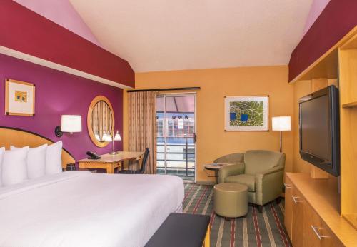 a hotel room with a bed and a flat screen tv at Pier 5 Hotel Baltimore in Baltimore
