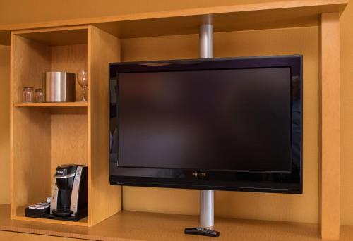 a flat screen tv on a shelf in a room at Pier 5 Hotel Baltimore in Baltimore