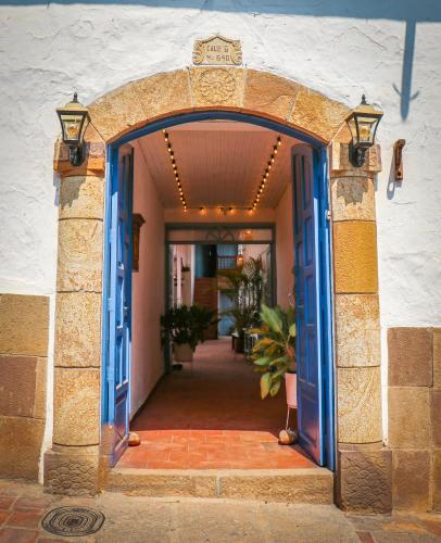 an entrance to a building with a blue doorway at Aura Hotel Parque Barichara By Infinity in Barichara