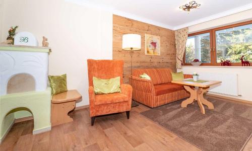 a living room with a chair and a table at Bachmann Appartements in Sankt Anton am Arlberg