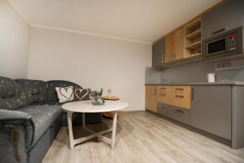 a living room with a couch and a table at Pension Ayky in Jablonec nad Nisou