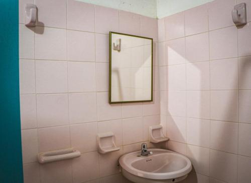 a bathroom with a sink and a mirror at Aura Hotel Parque Barichara By Infinity in Barichara
