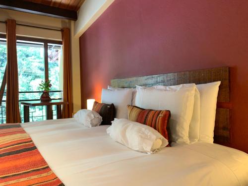 a bedroom with two beds with white pillows at Panorama B&B in Machu Picchu