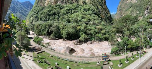 arial view of a mountain with a road and trees at Panorama B&B in Machu Picchu