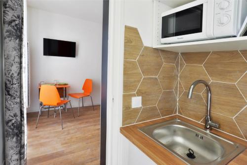 a kitchen with a sink and a microwave at Chez Alycelia - Studio - Orly - Gare - 25' Paris centre in Juvisy-sur-Orge