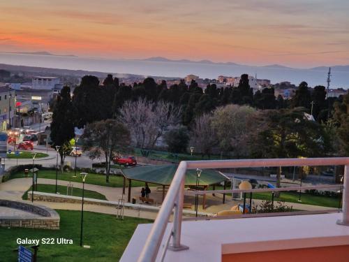 a view of a city at sunset from a balcony at Palazzo Pisano Sorso-Tourist Rental in Sorso