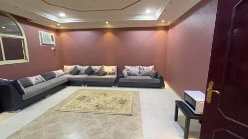 a living room with a couch and a rug at شقة فندقية in Al Madinah