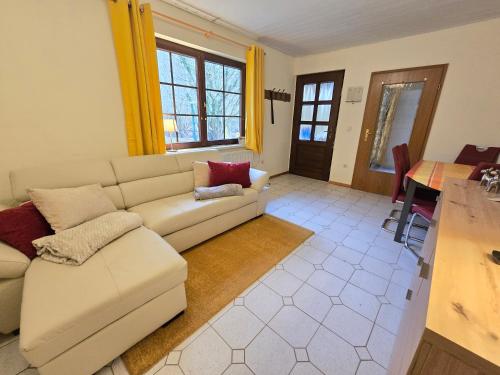 a living room with a couch and a table at Haus Seezeit in Plau am See