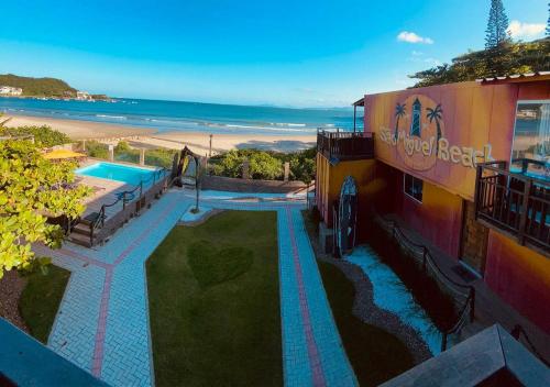 a resort with a swimming pool next to the beach at Pousada São Miguel Beach Beira Mar in Penha