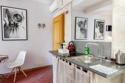 a kitchen with a sink and a counter at Centre Palais des Papes-Balcon B1 Clim - 123avignon in Avignon