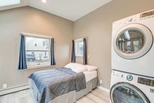 a laundry room with a bed and a washer and dryer at Cozy Maine Getaway Covered Deck, Walk to Beach! in Lubec