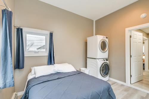 a bedroom with a bed and a washing machine at Cozy Maine Getaway Covered Deck, Walk to Beach! in Lubec