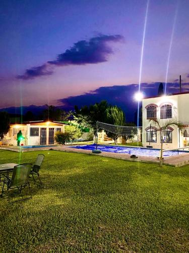 een huis met een gazon er 's nachts voor bij Quinta Rinos in Los Limones
