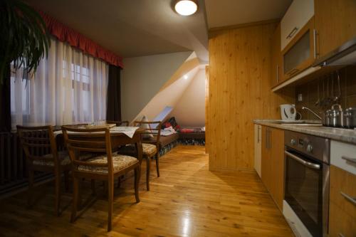 a kitchen and dining room with a table and chairs at Pension Ayky in Jablonec nad Nisou