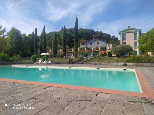 a swimming pool in front of a house at Shabby House in Podere Modello