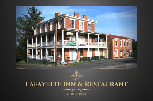 a large red brick building on the corner of a street at The Lafayette Inn & Restaurant in Stanardsville