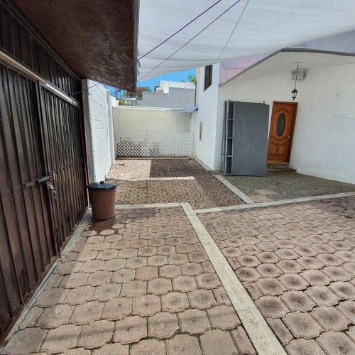 an empty patio with a door and a building at Warriors Burgos in Temixco