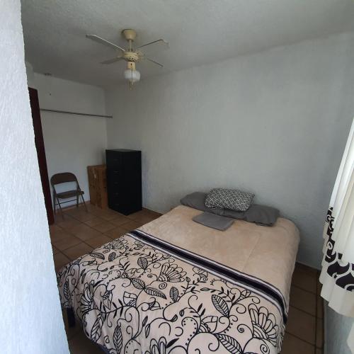 a bedroom with a bed and a ceiling fan at Warriors Burgos in Temixco