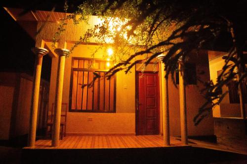 a front door of a house at night at Amarula Tree Hotel Mikumi in Mikumi