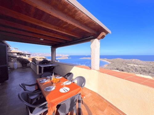 a table on a balcony with a view of the ocean at PUNTA EST QUADRILOCALE TERRAZZA FAVOLOSA VISTA MARE in Capo Coda Cavallo