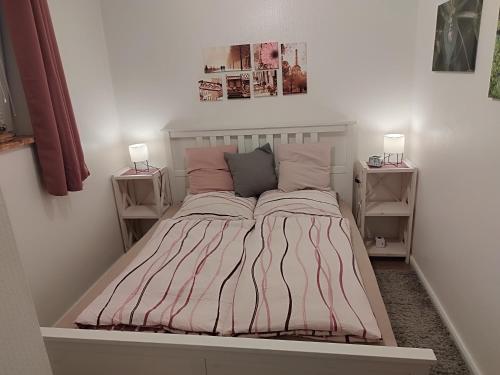 a bedroom with a bed with two night stands at Ferienwohnung Sielbeck, Urlaub mit Hund, WLAN verfügbar in Eutin