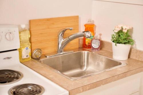 a kitchen counter with a sink in a kitchen at NEW Gorgeous Space in Moose Jaw Coffee Parking 4k Smart TV in Moose Jaw