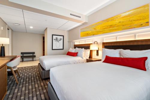 a hotel room with two beds and a desk at The Knight Center at Washington University in University City