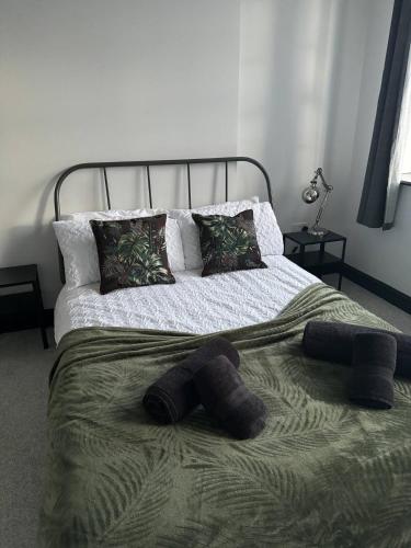 a bed with two mitts on top of it at The Lowther Penthouse - 2 Bedrooms - Sleeps 4 in Whitehaven