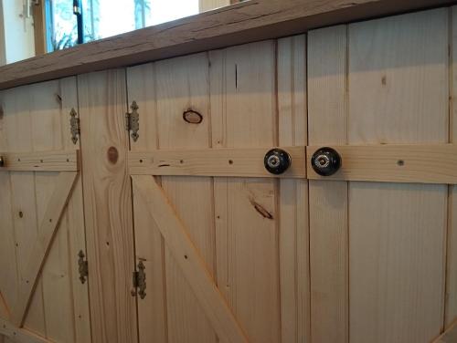 a set of wooden cabinets with metal handles at Ajurweda na Jurze Agroturystyka in Choroń
