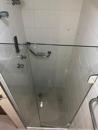 a shower with a glass door in a bathroom at Flat Hotel Mercure - 4 Estrelas Moema SP in Sao Paulo