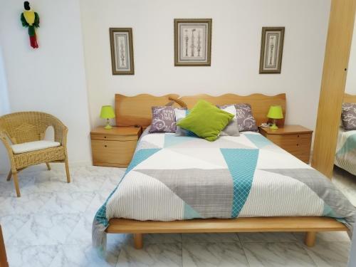a bedroom with a bed and a chair at Vistas Al Mar E Isla De La Toja in O Grove