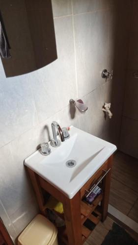 a bathroom with a sink and a toilet at Cabañas Aliwen in Puerto Bossetti