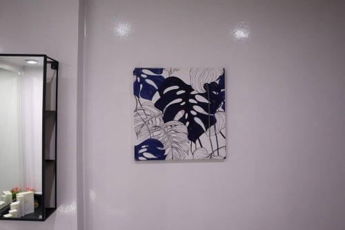 een schilderij van blauwe vlinders aan een muur bij Divine 1BR Apartment in Al Reef. in Yas Island