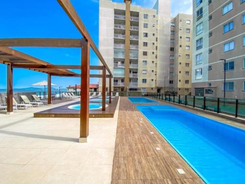 an image of a swimming pool at a apartment complex at Resort Apto Frente Mar in Barra Velha