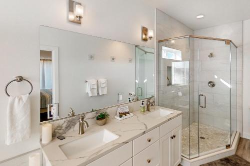 a white bathroom with a sink and a shower at The Luxe Overlook in Oceano